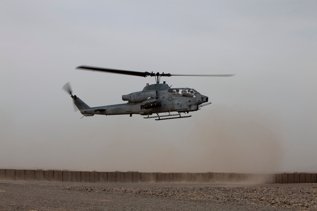 An AH-1 Super Cobra begins its descent onto a landing zone for re-fueling and re-supplying at Forward Arming and Refueling Point Ouellette, Afghanistan, April 5, 2011. The Vipers of Marine Light Attack Helicopter Squadron 169 transferred their responsibility of providing close air support in Regional Command Southwest to HMLA-267, at Camp Bastion, Afghanistan, May 19.