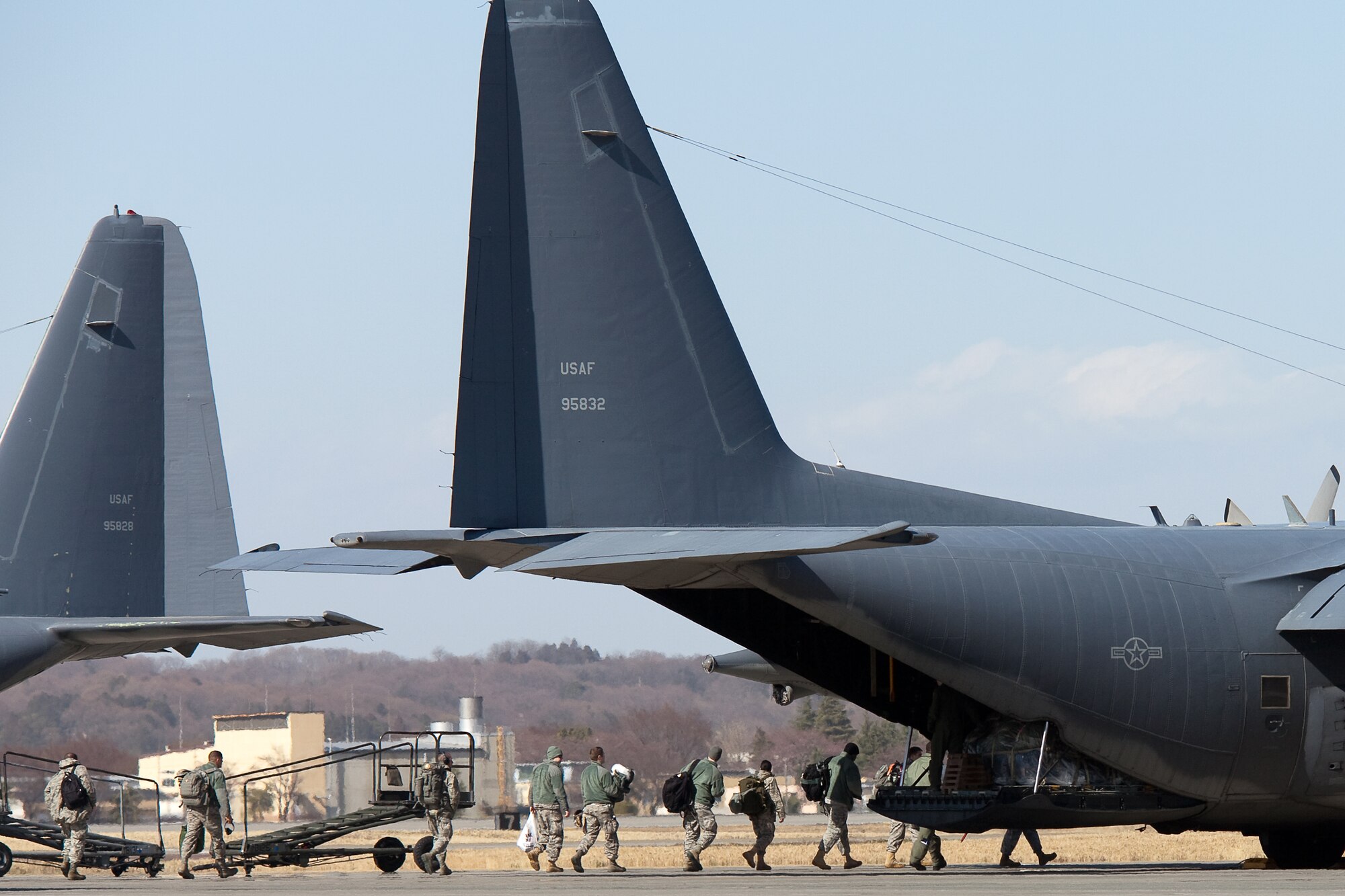 YOKOTA AIR BASE, Japan -- Airmen from Kadena Air Base board a MC-130P to return home April 4, 2011. The Combat Shadows have been here at Yokota providing constant support since the start of Operation Tomodachi. More than 14,000 personnel, 140 aircraft, and 20 ships from the U.S. military have been involved in the relief effort. (U.S. Air Force photo/Osakabe Yasuo)