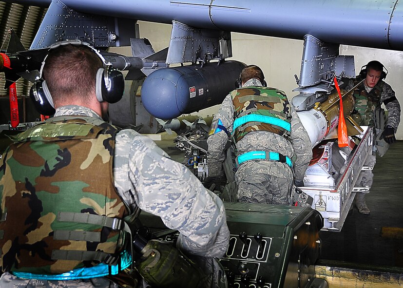 A weapons loading team from the 25th Fighter Squadron, loads bombs on an A-10 at Osan Air Base, Republic of Korea, April 4.  The base is practicing increased security measures during the 2011 Korea Pacific Air Forces Command Operational Readiness Inspection.  An ORI is conducted to evaluate and measure the ability of units with wartime, contingency or force sustainment mission to perform operations plan and assigned tasks.  Inspectable areas include initial response, employment, mission support and Ability-to-Survive and Operate in a chemical environment. (U.S. Air Force photo/Staff Sgt/ Daylena Gonzalez)