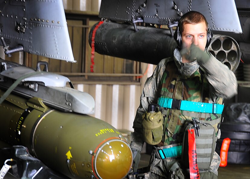 A weapons loading team from the 25th Fighter Squadron, loads bombs on an A-10 at Osan Air Base, Republic of Korea, April 4.  The base is practicing increased security measures during the 2011 Korea Pacific Air Forces Command Operational Readiness Inspection.  An ORI is conducted to evaluate and measure the ability of units with wartime, contingency or force sustainment mission to perform operations plan and assigned tasks.  Inspectable areas include initial response, employment, mission support and Ability-to-Survive and Operate in a chemical environment. (U.S. Air Force photo/Staff Sgt. Daylena Gonzalez)