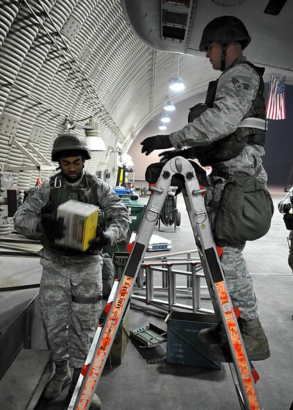Senior Airmen Kevin Benberry and Travis VanCott prepare to load an A-10 with flares and chaff at Osan Air Base, Republic of Korea, April 4.  The base is practicing increased security measures during the 2011 Korea Pacific Air Forces Command Operational Readiness Inspection.  An ORI is conducted to evaluate and measure the ability of units with a wartime, contingency orforce sustainment mission to perform operations plan and assigned tasks.  Inspectable areas include initial response, employment, mission support and Ability-to-Survive and Operate in a chemical environment.  (U.S. Air Force Photo by Senior Airman Evelyn Chavez)