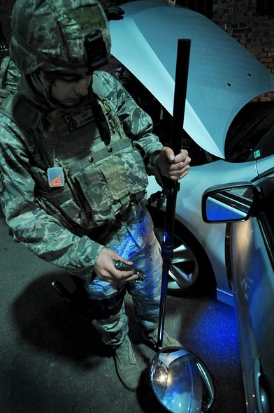 Airman 1st Class Colton Demierre, 51st Security Forces Squadron, inspects a vehicle at Osan Air Base, Republic of Korea, April 3.  The base practicing increased security measures during the 2011 Korea Pacific Air Forces Command Operational Readiness Inspection.  An ORI is conducted to evaluate and measure the ability of units with a wartime, contingency orforce sustainment mission to perform operations plan and assigned tasks.  Inspectable areas include initial response, employment, mission support and Ability-to-Survive and Operate in a chemical environment.  (U.S. Air Force Photo by Senior Airman Evelyn Chavez)