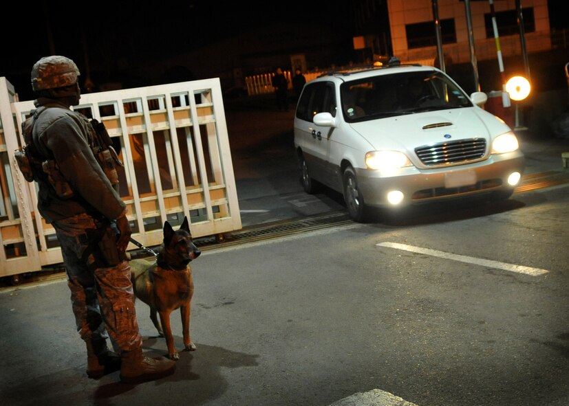 Staff Sgt. Rufus Watson, 51st Security Forces Squadron, prepares to inspect a vehicle at Osan Air Base, Republic of Korea, April 3.  The base is practicing increased security measures during the 2011 Korea Pacific Air Forces Command Operational Readiness Inspection.  An ORI is conducted to evaluate and measure the ability of units with a wartime, contingency orforce sustainment mission to perform operations plan and assigned tasks.  Inspectable areas include initial response, employment, mission support and Ability-to-Survive and Operate in a chemical environment.  (U.S. Air Force Photo by Senior Airman Evelyn Chavez)