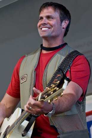 NELLIS AIR FORCE BASE, Nev. -- Country singer, Troy Gentry from Montgomery Gentry performs onstage during the Academy of Country Music USO concert at the Nellis sports pavilion April 2.Country music stars came to Nellis to participate in a charity skeet shooting event and perform a free concert for military members and their families. ( U.S Air Force Photo by Airman 1st Class Daniel Hughes)