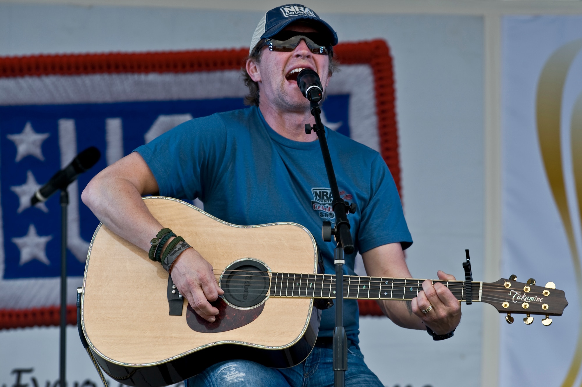 NELLIS AIR FORCE BASE, Nev. -- Country singer, Craig Morgan performs his hit single "International Harvester" onstage during the Academy of Country Music USO concert at the Nellis sports pavilion April 2. Country music stars came to Nellis to participate in a charity skeet event and a free convert for military members and their families. ( U.S Air Force Photo by Airman 1st Class Daniel Hughes)