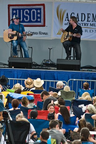 NELLIS AIR FORCE BASE, Nev. -- Country singer, Craig Morgan performs his hit song"Redneck Yacht Club" onstage during the Academy of Country Music USO concert at the Nellis sports pavilion April 2. Country music stars came to Nellis to participate in a charity skeet event and a free convert for military members and their families. ( U.S Air Force Photo by Airman 1st Class Daniel Hughes)