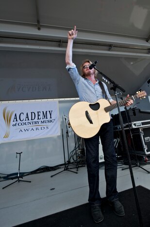 NELLIS AIR FORCE BASE, Nev. -- Country singer, Phillip Sweet from the  band Little Big Town performs onstage during the Academy of Country Music USO concert at the Nellis sports pavilion April 2. Country music stars came to Nellis to participate in a charity skeet event and a free convert for military members and their families. ( U.S Air Force Photo by Airman 1st Class Daniel Hughes)