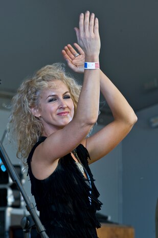 NELLIS AIR FORCE BASE, Nev. -- Country singer, Kimberly Schlapman from the band Little Big Town dances onstage during the Academy of Country Music USO concert at the Nellis sports pavilion April 2. Country music stars came to Nellis to participate in a charity skeet shooting event and perform a free concert for military members and their families. ( U.S Air Force Photo by Airman 1st Class Daniel Hughes)