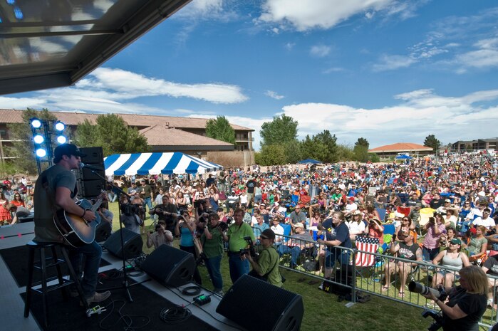 NELLIS AIR FORCE BASE, Nev. -- Country singer, Luke Bryan performs onstage during the Academy of Country Music USO concert at the Nellis sports pavilion April 2. Country music stars came to Nellis to participate in a charity skeet shooting event and perform a free concert for military members and their families. ( U.S Air Force Photo by Airman 1st Class Daniel Hughes)