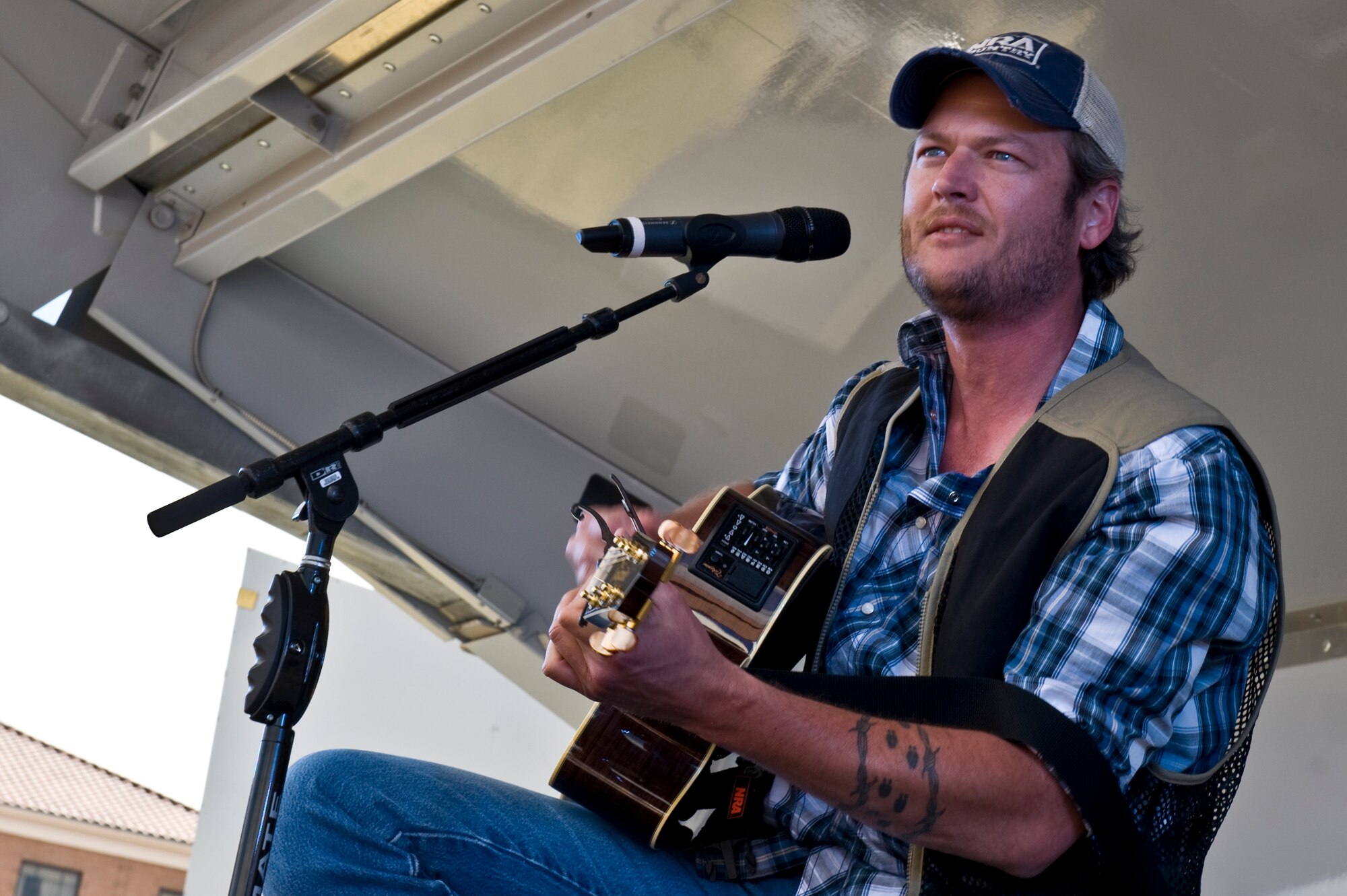 NELLIS AIR FORCE BASE, Nev. -- Country singer, Blake Shelton performs onstage during the Academy of Country Music USO concert at the Nellis sports pavilion April 2. Country music stars came to Nellis to participate in a charity skeet shooting event and perform a free concert for military members and their families. ( U.S Air Force Photo by Airman 1st Class Daniel Hughes)