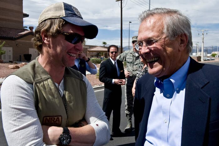 NELLIS AIR FORCE BASE, Nev. -- Country music star Craig Morgan speaks with former Secretary of Defense Donald Rumsfeld who was in attendance for the Academy of Country Music USO concert at the Nellis sports pavilion April 2. Country music stars came to Nellis to participate in a charity skeet shooting event and perform a free concert for military members and their families.(U.S Air Force Photo by Airman 1st Class Daniel Hughes)