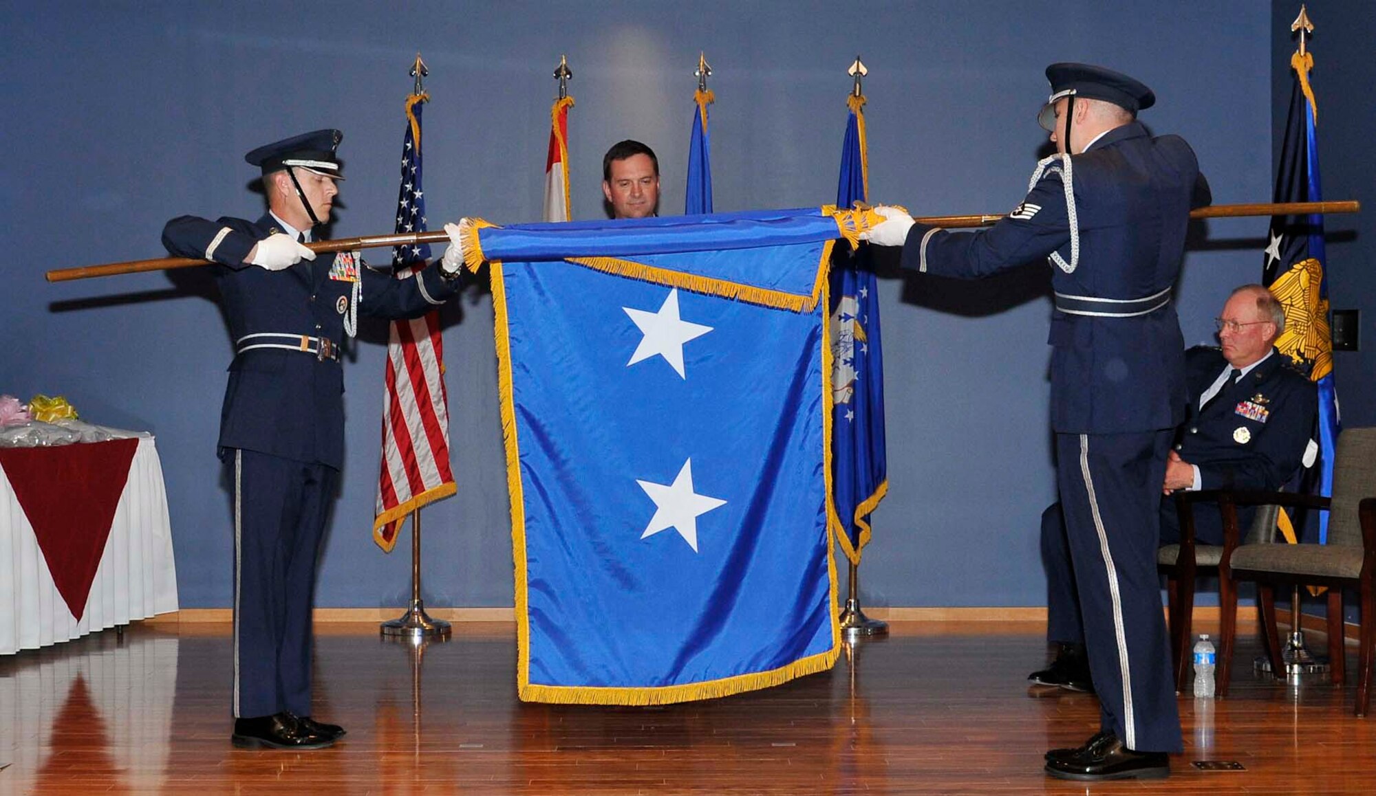 Maj. Gen. Joseph Lengyel (center) watches as members of the Honor Guard unfurl a major general flag in his honor during his promotion ceremony at Tyndall Air Force Base, Fla., April 1. General Lengyel is the 1st Air Force (Air Forces Northern) vice commander. (U.S. Air Force photo by Lisa Norman)