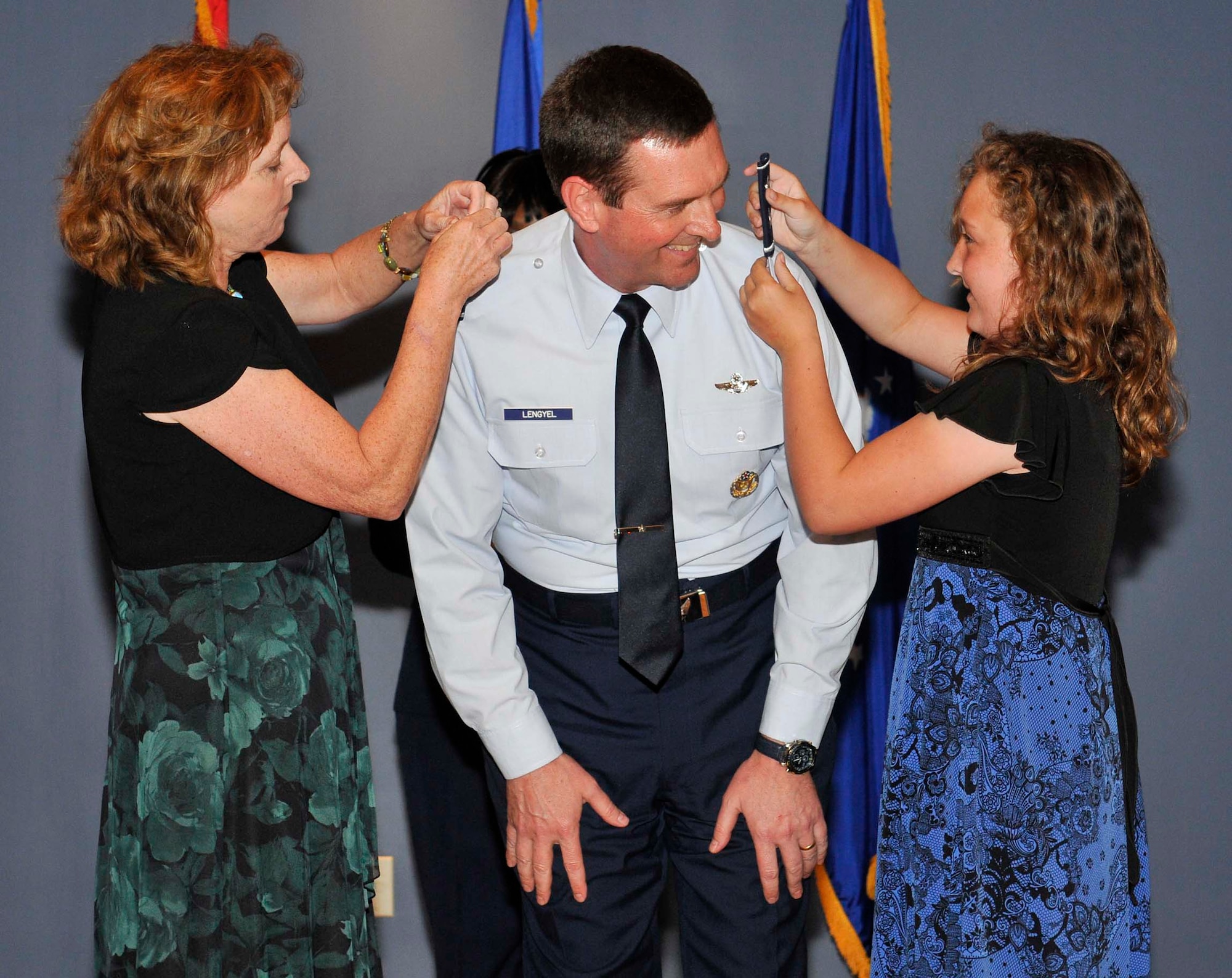 Maj. Gen. Joseph Lengyel smiles at his daughter Katie as she and his wife Sally put on his new epaulets during his promotion ceremony at Tyndall Air Force Base, Fla., April 1. General Lengyel is the 1st Air Force (Air Forces Northern) vice commander. (U.S. Air Force photo by Lisa Norman)