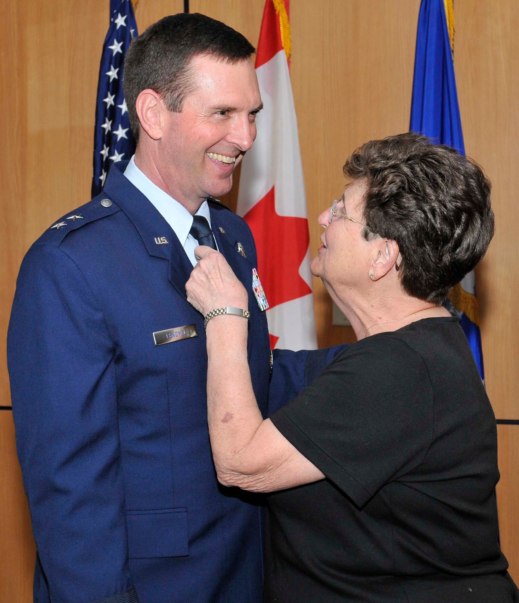 Maj. Gen. Joseph Lengyel shares a laugh with his mother Margaret Lengyel as she straightens his tie before his promotion ceremony at Tyndall Air Force Base, Fla., April 1. General Lengyel is the 1st Air Force (Air Forces Northern) vice commander. (U.S. Air Force photo by Lisa Norman)