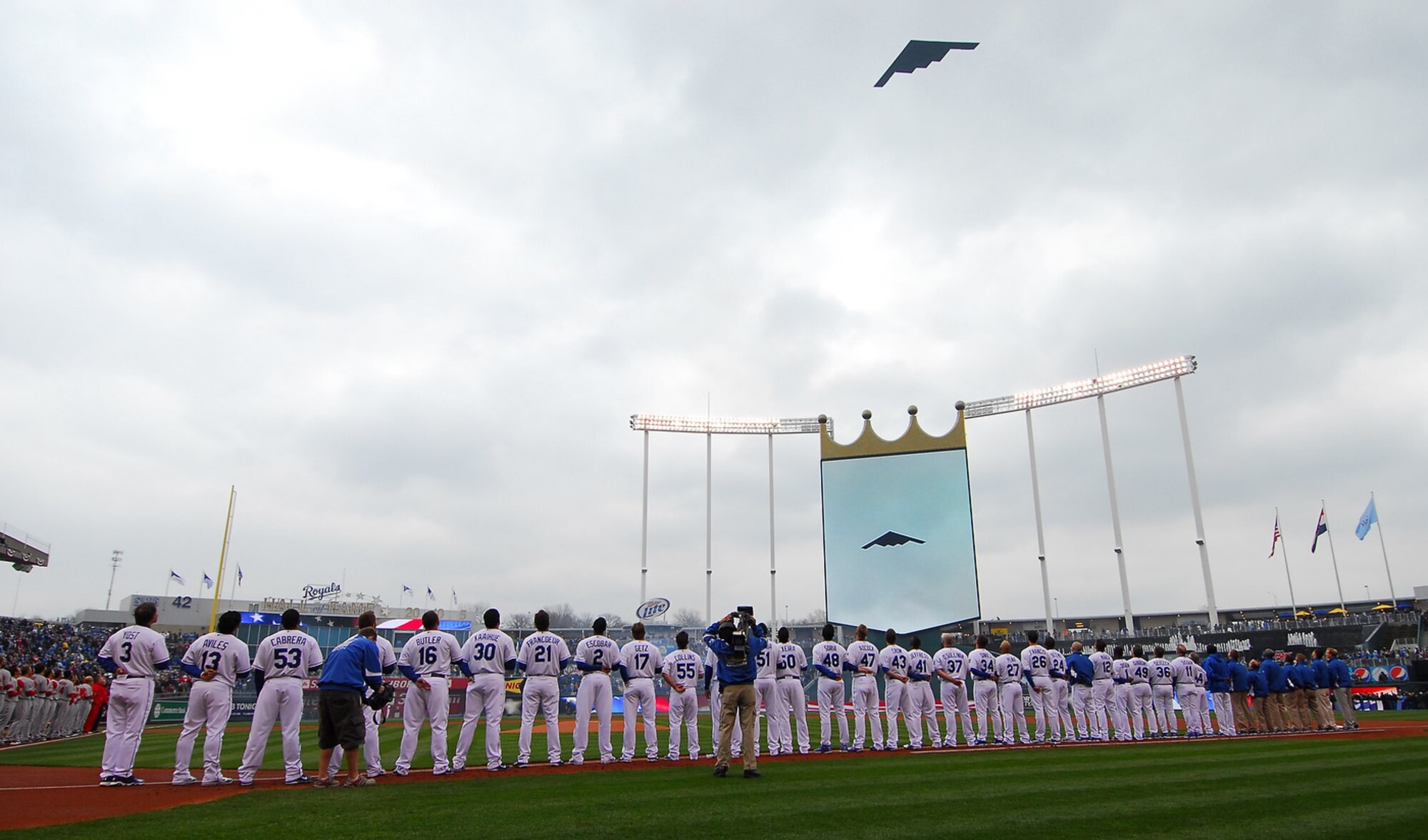 An Air Force Global Strike Command B-2 Spirit stealth bomber crew from Whiteman Air Force Base, Mo., performs a B-2 flyover at the season opener for the Kansas City Royals March 31 in Kansas City. B-2s recently returned to Whiteman after striking targets in Libya in support of Operation Odyssey Dawn. (Courtesy photo/Kansas City Royals)