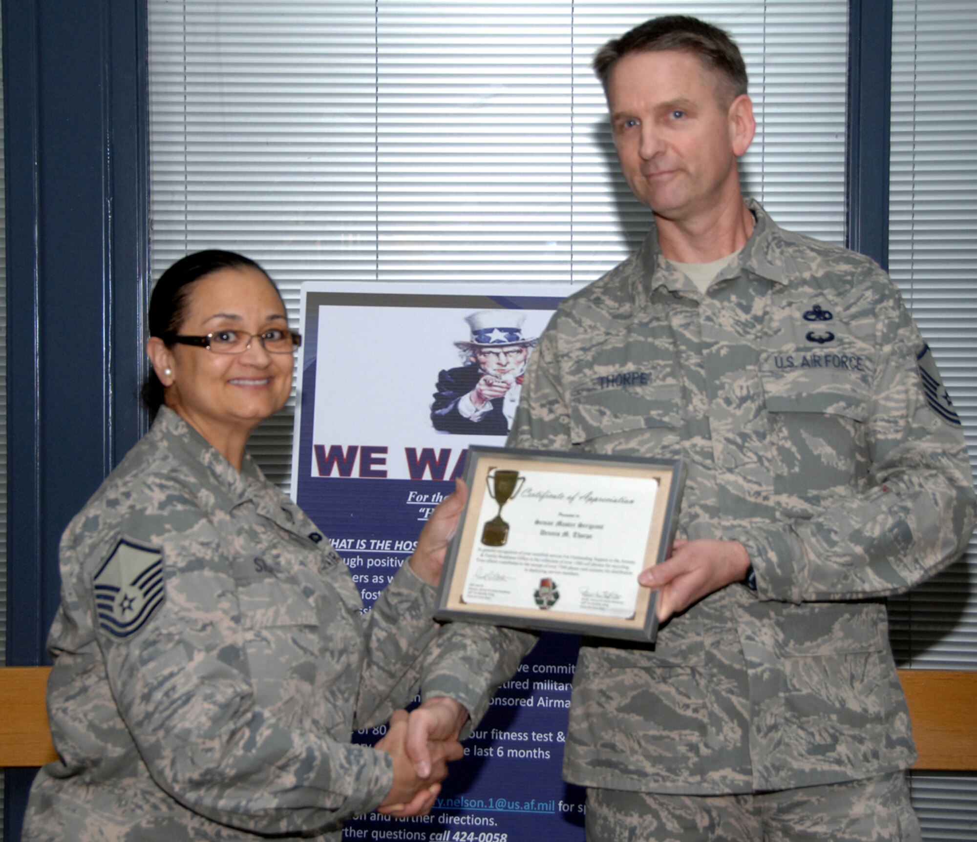 TRAVIS AIR FORCE BASE, Calif. -- Master Sgt. Trevor Thorpe, 349 Aircraft Maintenance Squadron, was awarded a certificate of appreciation March 26 for his support with the Airman and Family Readiness cell phone collection program by Master Sgt. Pam Silas. Thorpe's civilian company, XO Communications, donated more than 1,500 cell phones and accessories which resulted in the Lyons Club donating more than 7,500 calling card minutes which is given to wing members that deploy and attend basic training. This gives the wing members a way to stay in touch with their families back home.   (U.S. Air Force photo/Master Sgt. Robert Wade)