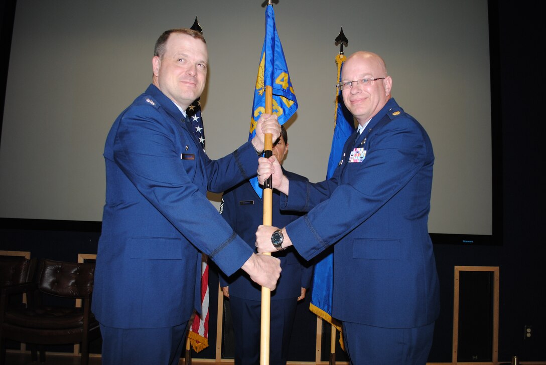 Col. Craig S. Petersen, 433rd Mission Support Group commander, hands off the 433rd Logistics Readiness Squadron guidon to  Maj. David C. Eastham Jr., who officially took over the Alamo Wing's logistics readiness unit during an assumption of command ceremony. The ceremony took place April 2, 2011 at the 68th Airlift Squadron auditorium on Lackland Air Force Base, Texas. (U.S. Air Force photo/Senior Airman Luis Loza Gutierrez)