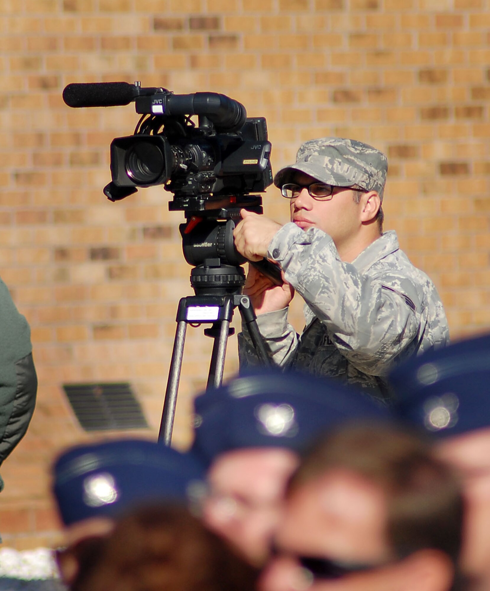 GOODFELLOW AIR FORCE BASE, Texas -- Staff Sgt. Michael Falvo, 17th Training Wing Public Affairs, films a building dedication ceremony here Nov. 8, 2010. Sergeant Falvo was recently awarded first place in the 2010 Air Force Media Contest for his news report on Goodfellow’s August 2010 Active Shooter exercise. There are more than 30 videos produced on Goodfellow each year, and last year Sergeant Falvo either assisted with or produced on his own 25 of them. (U.S. Air Force photo/Staff Sgt. Heather Rodgers)