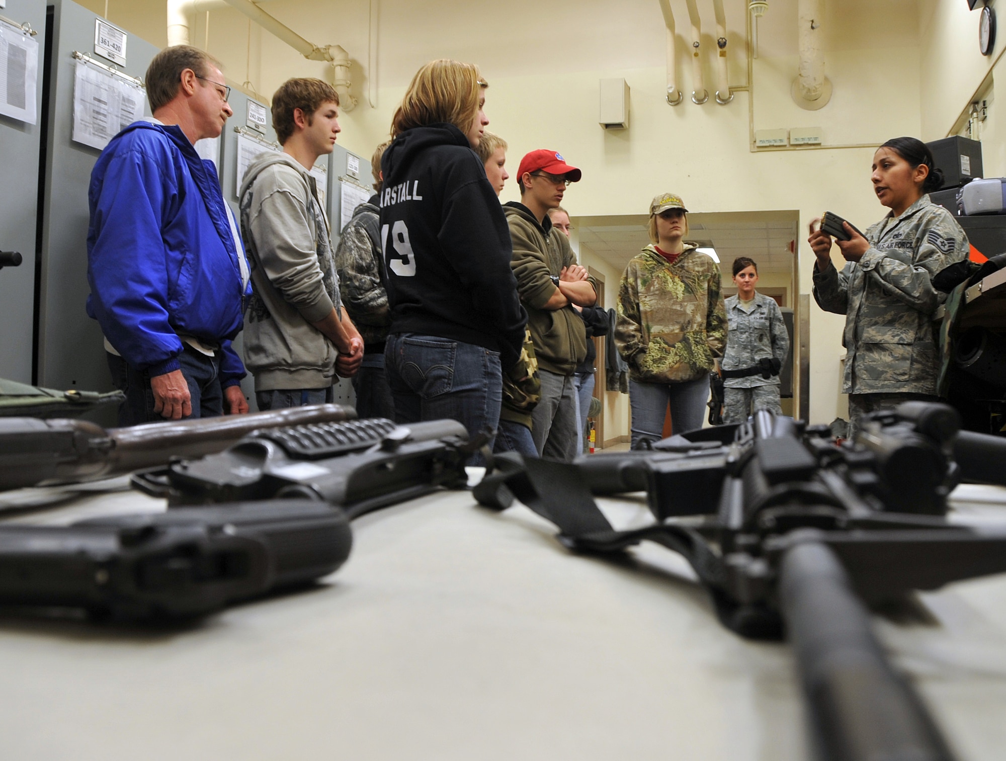 OFFUTT AIR FORCE BASE, Neb. -- Staff Sgt. Tracy Howard, NCO in charge of the 55th Security Forces armory, displays a 30-round magazine and explains how the magazine is utilized to eight students from St. Mary's High School (Kansas) in the armory here March 24. The students visited the armory as part of a base tour. U.S. Air Force Photo by Jeff W. Gates