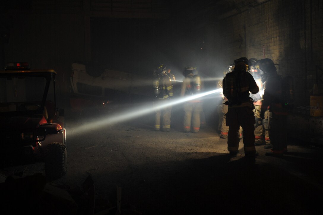 Members of the 11th Civil Engineer Squadron fire department access the entry way to the mock mass causality disaster in the commissary at the Center for National Response in Gallagher, W. Va, March 31. The fire department preformed search and rescue procedures. (U.S. Air Force photo by Senior Airman Melissa V. Brownstein)
