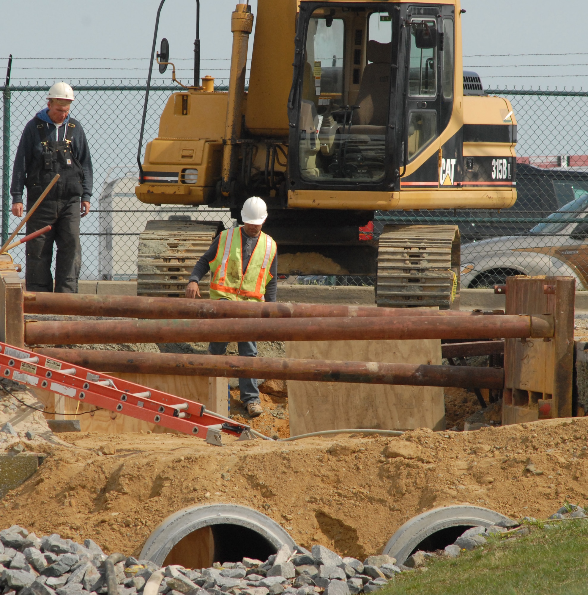 James Comegys (left) and Ryan Meisinger, contractors, prep a drainage tunnel for work April 4, 2011, at Dover Air Force Base, Del. The construction is part of a $2 million project for drainage maintenance on Dover AFB. (U.S. Air Force photo by Airman 1st Class Matthew Hubby)