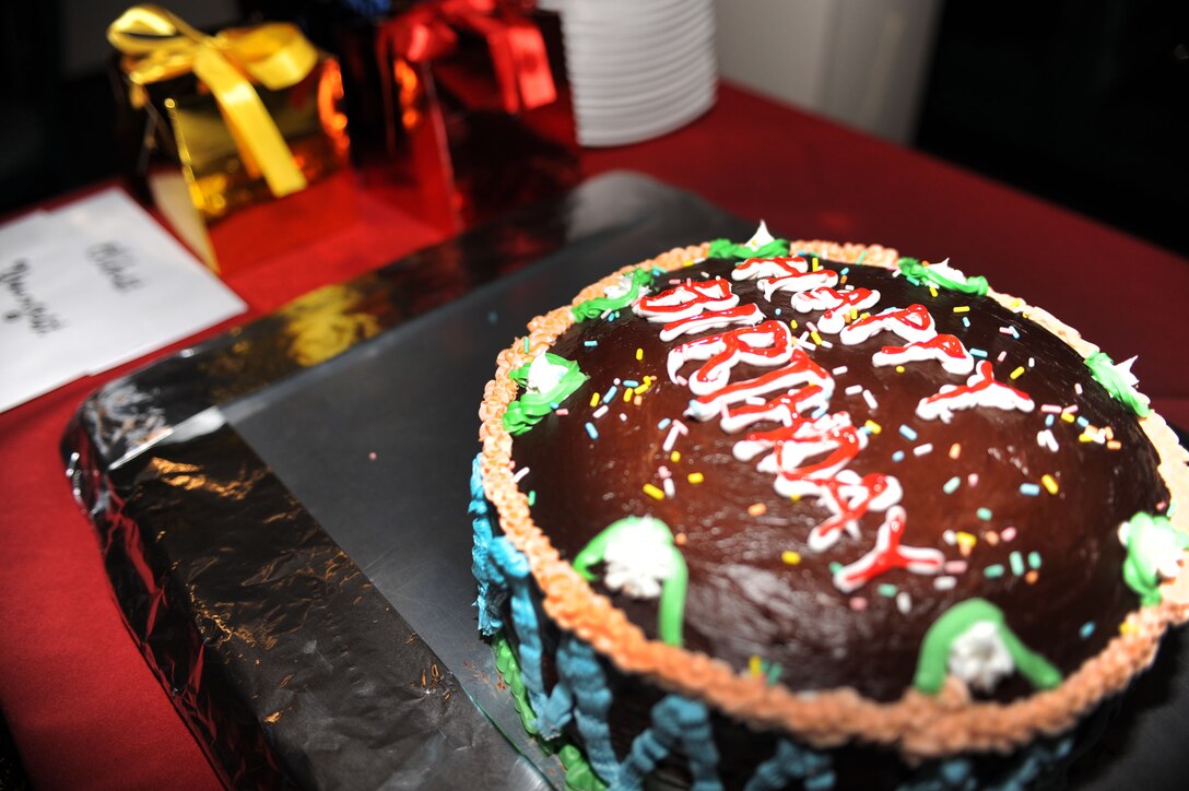 A birthday cake is presented to Langley Air Force Base, Va. dorm residents during the reinstitution of birthday meals, March 31, 2011. The dining facility honors dorm resident birthdays each month with a special meal in their honor. (U.S. Air Force photo by Senior Airman Brian Ybarbo/Released) 