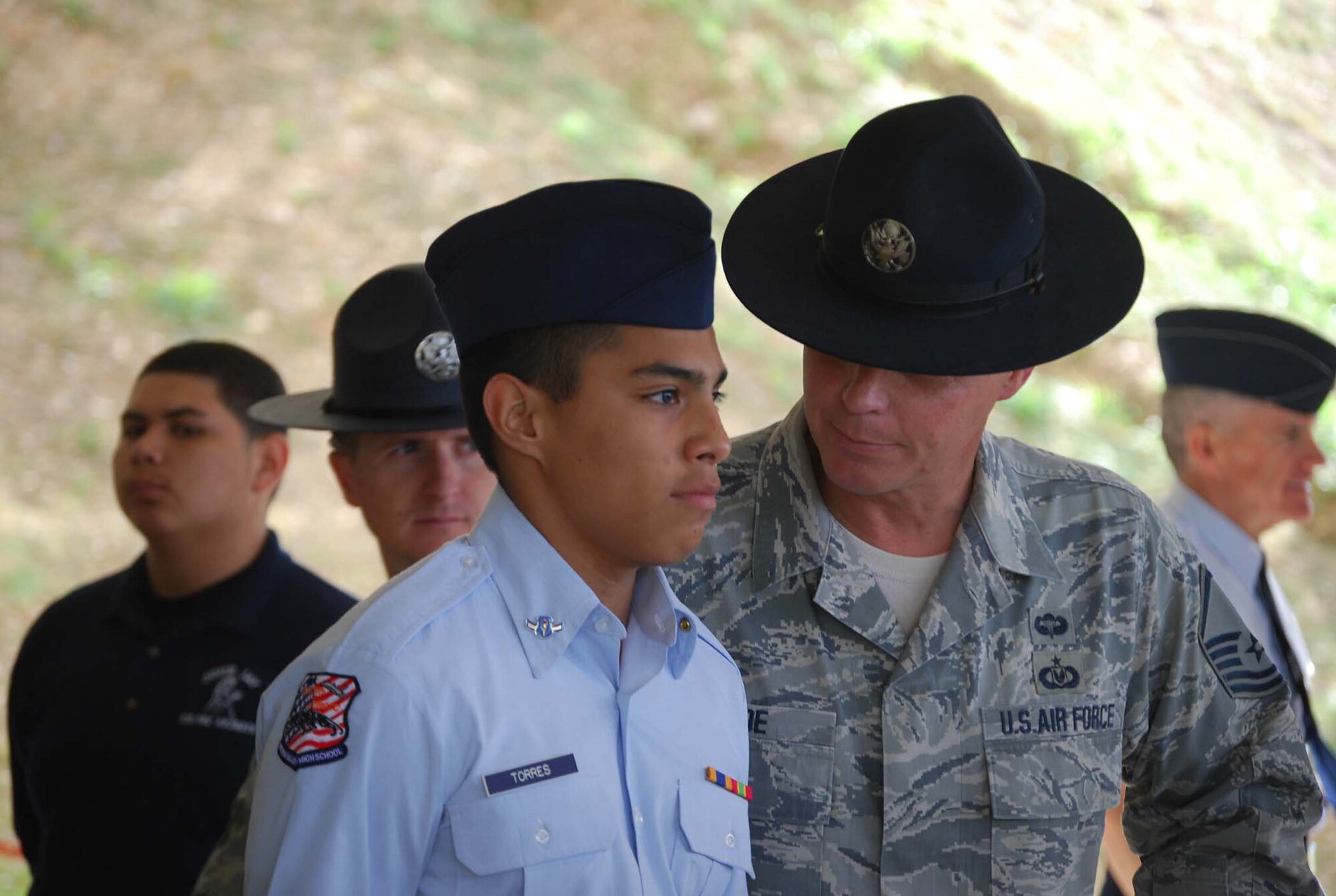 Medina Valley High School cadet commander Torres looks on with confidence as Master Sergeant Terrance Thoe, a 433rd military training instructor, inspects his uniform. The high school visited the unit during the 13th annual Junior ROTC day held at the Alamo Wing April 1st.  (U.S. Air Force photo/ Senior Airman Viola M. Hernandez)  