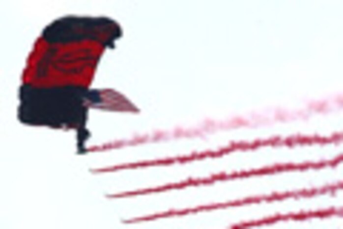A Black Dagger makes his entrance while streaming smoke. The Black Daggers are the official U.S. Army Special Operations Command Parachute Demonstration team. (Photo courtesy/U.S. Army)