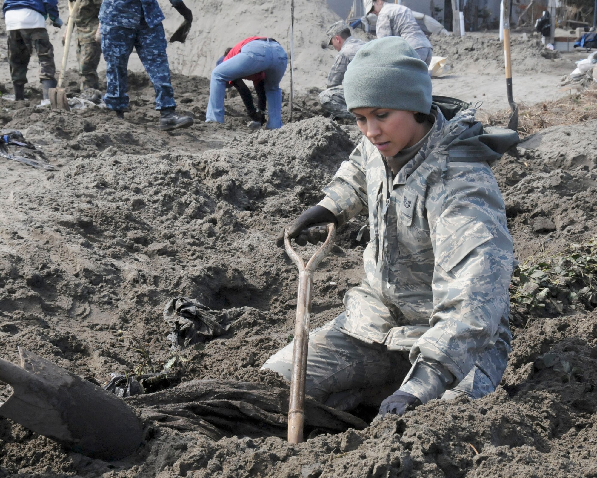 An Airman digs through a strawberry field, looking for debris April 1, 2011, in Hachinohe, Japan. (U.S. Air Force photo/Staff Sgt. Rachel Martinez)