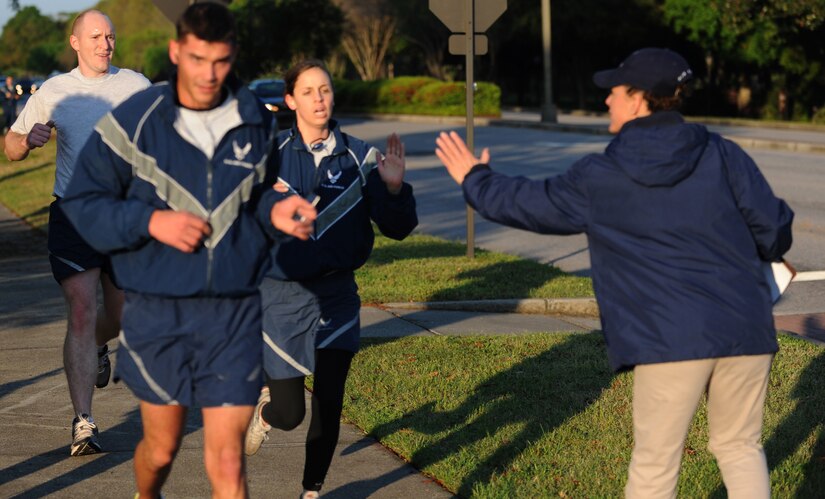 Capt. Michaela Judge sprints towards the finish line and finishes first in the female category during the Commander's Fitness Challenge April 1, 2011, on Joint Base Charleston, S.C. This month's fitness run was held to raise awareness of sexual assault and rape. Captain Judge is the video flight commander with the 1st Combat Camera Squadron. (U.S. Air Force photo/Senior Airman Timothy Taylor)(Released)