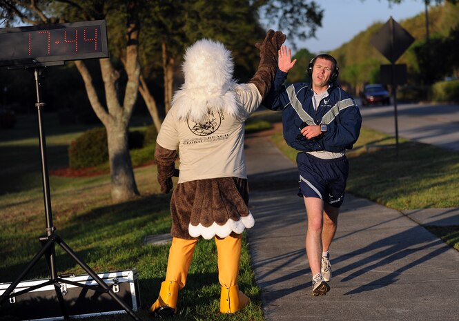 1st Lt. Ryan Peake took top honors in the men's category as he crosses the finish line during the Commander's Fitness Challenge April 1, 2011, on Joint Base Charleston, S.C. This month's fitness run was held to raise awareness of sexual assault and rape. Lieutenant Peake is the military personnel section chief with the 628th Force Support Squadron. (U.S. Air Force photo/Senior Airman Timothy Taylor)(Released)