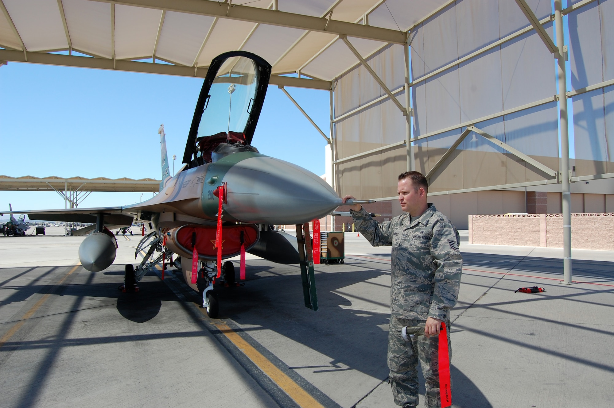 NELLIS AIR FORCE BASE, Nev. -- Tech. Sgt. Jonathan Jundt, 926th Aircraft Maintenance Squadron avionics craftsman, conducts an inspection of a pitot probe for the air data system on an F-16 Aggressor aircraft here April 1. (U.S. Air Force photo/Capt. Jessica Martin)