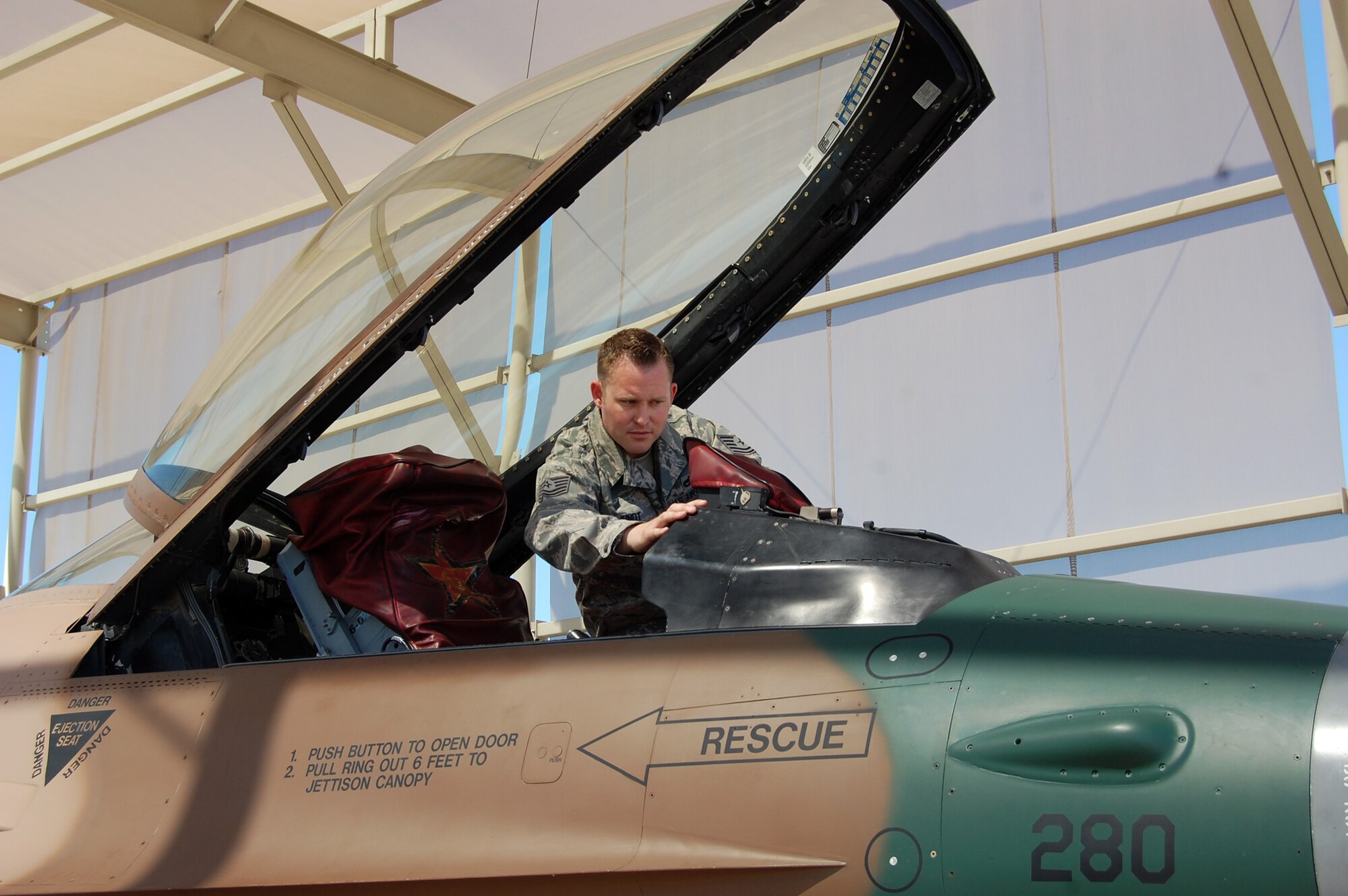 NELLIS AIR FORCE BASE, Nev. -- Tech. Sgt. Jonathan Jundt, 926th Aircraft Maintenance Squadron avionics craftsman, inspects cockpit panels on an F-16 Aggressor aircraft. Sergeant Jundt was distinguished as the Lieutenant General Leo Marquez Award's outstanding Technician Supervisor of 2010 for 10th Air Force on April 2.