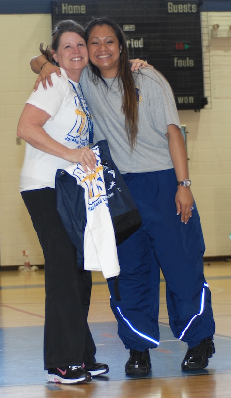 Rebecca Kendrick poses with Senior Airman Sokum Ouk, 633d Force Support Squadron fitness craftsman, after being announced as the female winner of Langley’s Biggest Loser at the Shellbank Fitness Center at Langley Air Force Base, Va., April 2, 2011.The competition is a 13 week program that encourages participants to maintain a healthy lifestyle by staying active and changing their eating habits. (U.S. Air Force photo by Airman 1st Class Teresa Zimmerman/Released)