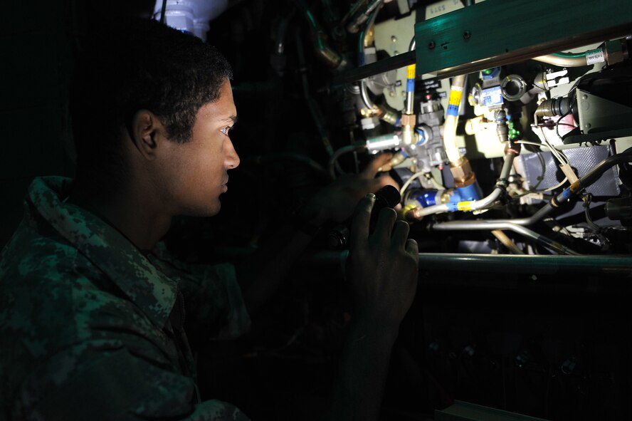 Senior Airman Bruce Allen, a 19th Aircraft Maintenance Squadron crew chief, performs a pre-flight check on the cargo deck of a C-130 Hercules on March 24, 2011, on the flightline of Little Rock Air Force Base, Ark. Airman Allen, along with other crew members, keeps the base aircraft flying the largest C-130 transport mission in the world. (U.S. Air Force Photo/Staff Sgt. Chris Willis)