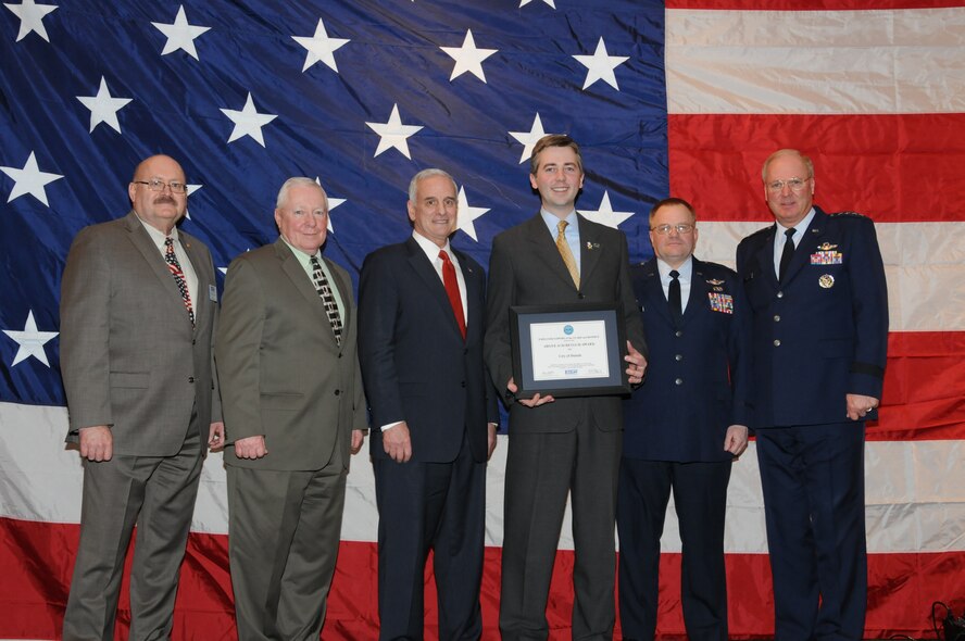 Don Ness (holding award), Mayor of Duluth, Minn. accepts the "Above and Beyond Award" for the City of Duluth during the Minnesota Employer Support for the Guard and Reserve (ESGR) Banquet held in Oakdale, Minn.  Mark Dayton (third from left), Governor of Minnesota and Gen. Craig McKinley, Chief, National Guard Bureau were on hand to present the awards.  (U.S. Air Force photo by Master Sgt. Ralph J. Kapustka)