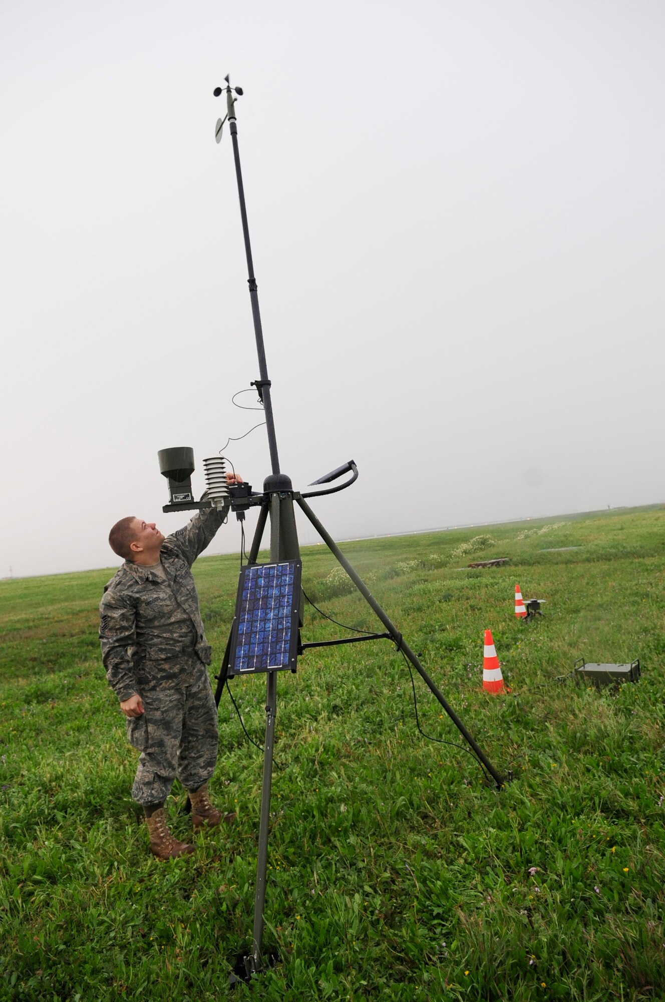 313th AIR EXPEDITIONARY WING (April 3, 2011) -- Tech. Sgt. Matthew Ordorff, 100th Air Refueling Wing weather technician, deployed from Royal Air Force Mildenhall, England, checks a AN/TMQ-53 Tactical Meteorology Sensor Suite in the rain, in support of Operation Unified Protector. Unified Protector is a NATO-led operation in Libya to protect civilians and civilian-populated areas under threat of attack.  (U.S. Air Force photo/Senior Airman Ethan Morgan)