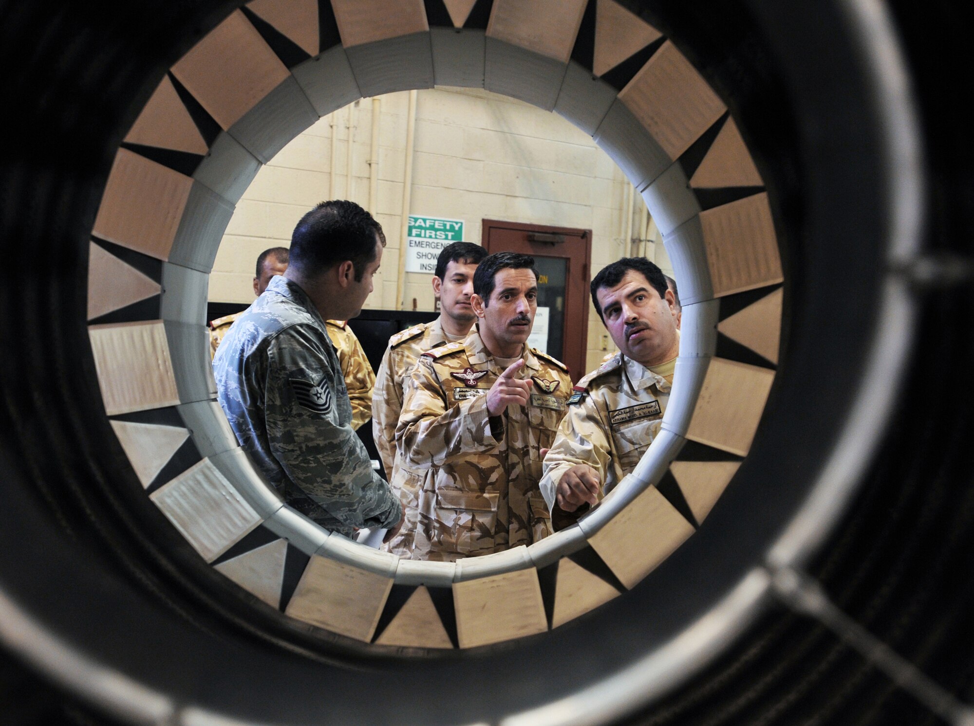 Tech. Sgt. Domingo Muniz shows Qatari air force officers an augmenter for an F-16 Fighting Falcon jet engine March 28, 2011, at Shaw Air Force Base, S.C. Qatar Emiri officers toured Shaw AFB to see how the installation does its various missions. Muniz is a 20th Component Maintenance Squadron aerospace propulsion craftsman. (U.S. Air Force photo/Airman 1st Class Tabatha Duarte)