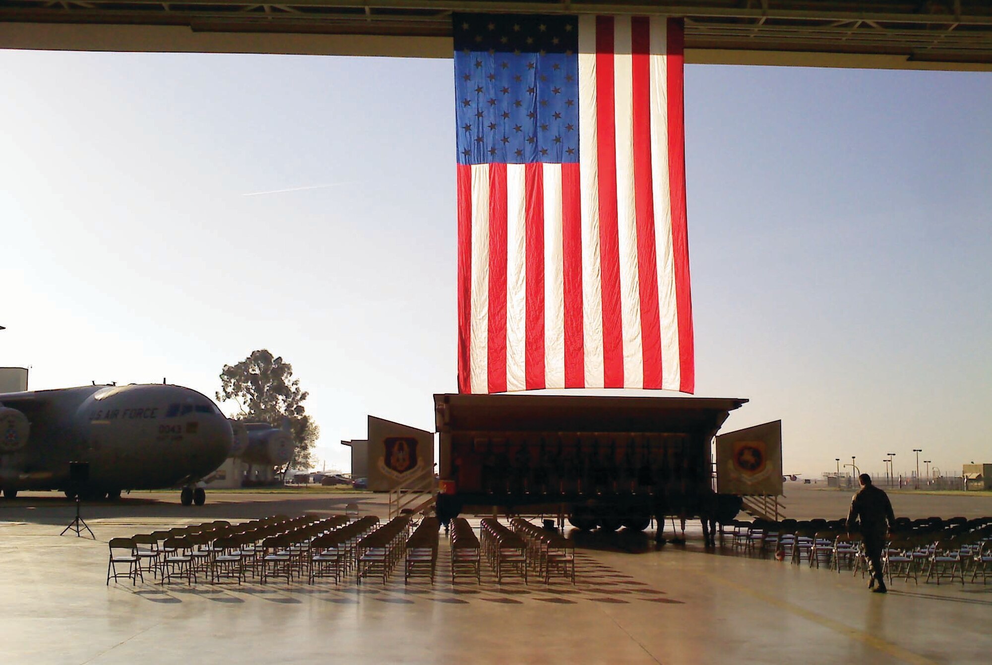 Staff Sgt. Jeff Faucher, 452nd Maintenance Squadron, inspects the seating area for the Fourth Air Force Change of Command, March 11, 2011. The backdrop is a garrison flag borrowed from Travis Air Force Base for the occasion.  (Courtesy photo) 