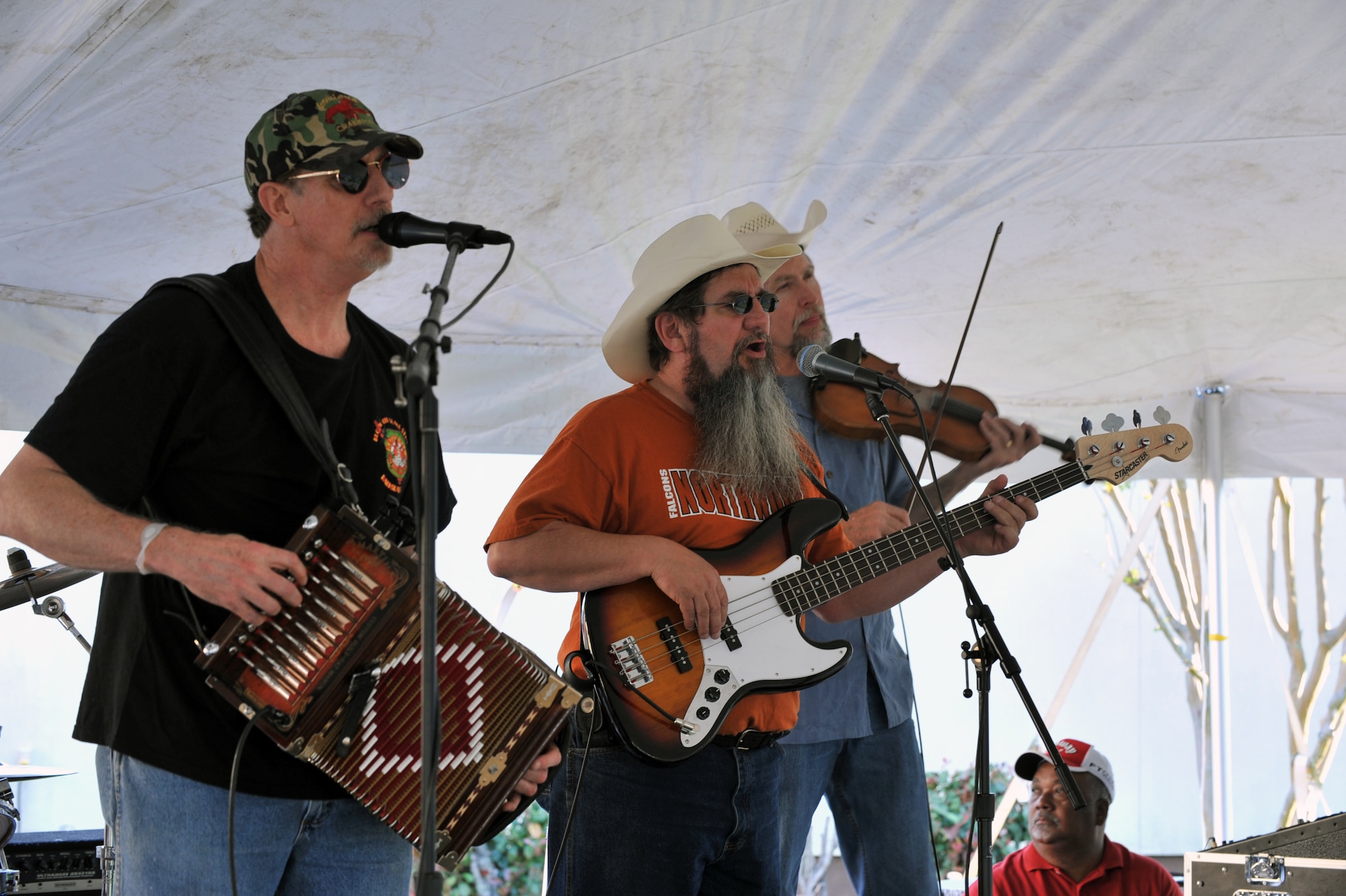 Members of the Red River Playboys perform at the Crawfish Festival on Barksdale Air Force Base, La., April 1. The band played cajun, zydeco, swamp pop, country, southern rock, and rhythm and blues. Free food, along with a crawfish eating contest, crawfish races and a moon bounce were some of the events held at the festival. (U.S. Air Force photo/ Airman 1st Class Micaiah Anthony)(RELEASED)