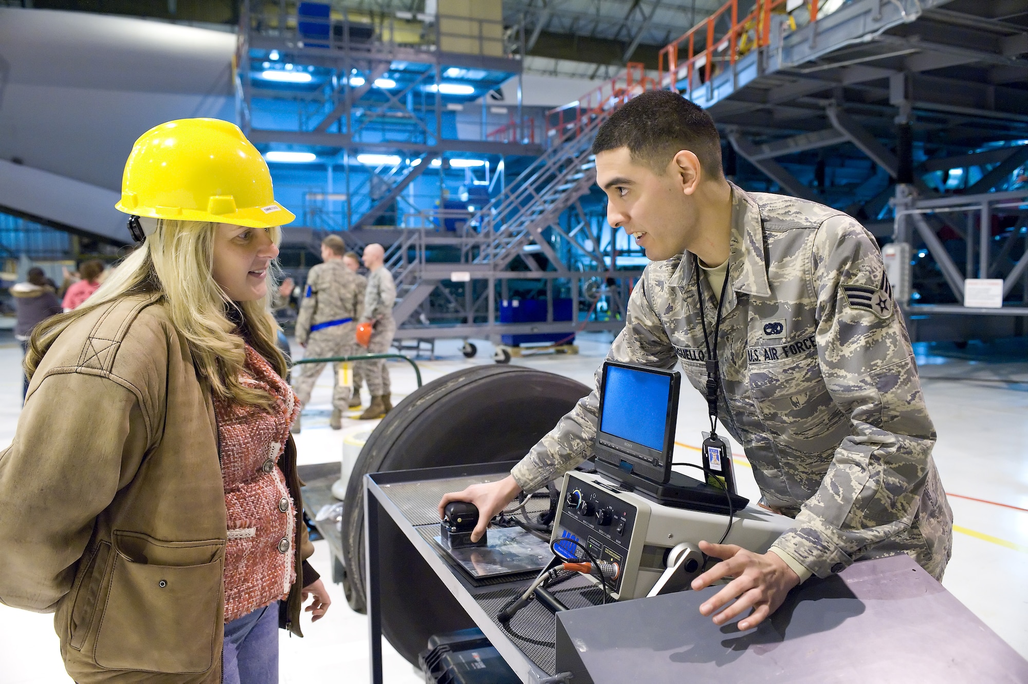 Carolyn Brandt, 436th Maintenance Squadron spouse, is shown an x-ray machine by Senior Airman Anthony Arguello April 1, 2011, in the Isochronal Dock at Dover Air Force Base, Del. (U.S. Air Force photo by Roland Balik)