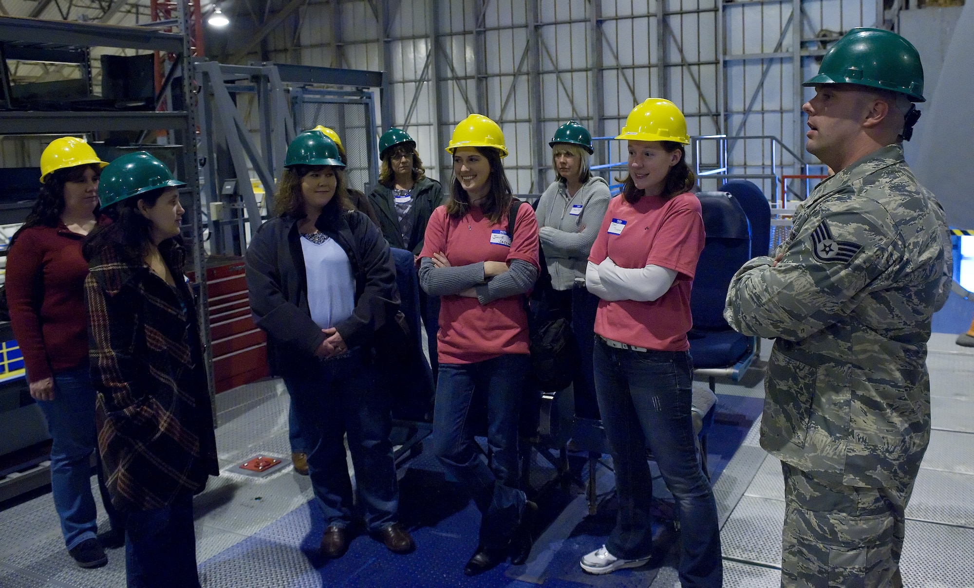 Key spouses from the 436th Maintenance Squadron stand on a platform outside the cockpit of a C-5  April 1, 2011, in the Isochronal Dock at Dover Air Force Base, Del. This was part of the in-depth C-5 tour spouses from the 436 MXS received.  (U.S. Air Force photo by Airman 1st Class Jacob Morgan)