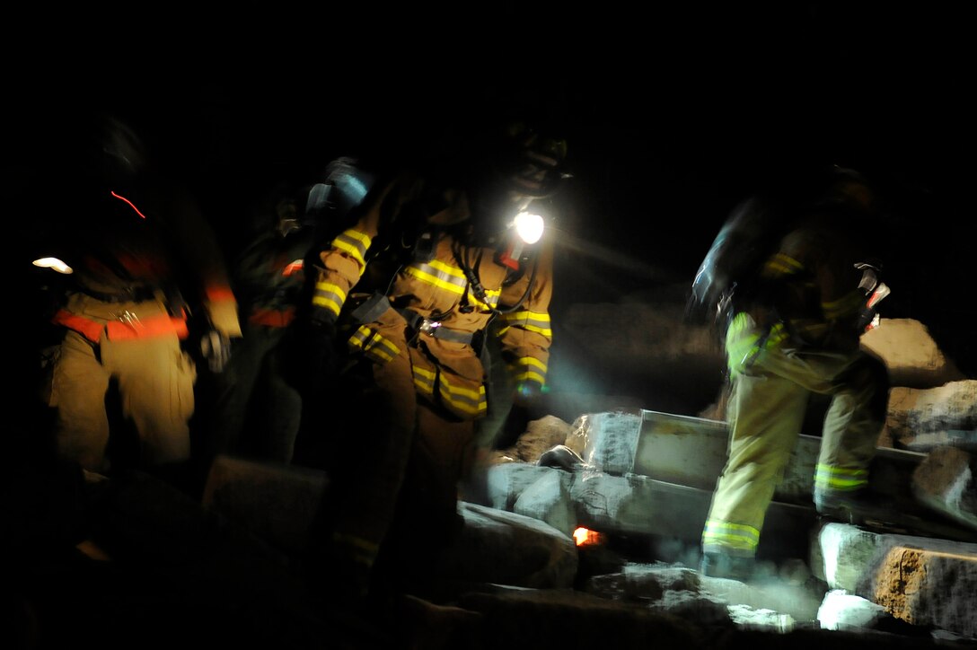 Members from the 11 Civil Engineer Squadron fire department perform a causality search inside the rubble room at the Center for National Response in Gallagher, W. Va, March 30. Personnel from the Air Force District of Washington participated in five days of exercising at the CNR, which provides state of the art weapons of mass destruction, counterterrorism and consequence management training and exercises along with operational on site equipment to help familiarize personnel.  (U.S. Air Force photo by Senior Airman Melissa V. Brownstein)