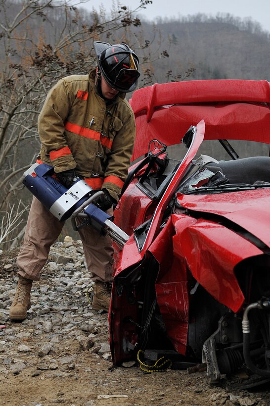 Senior Airman Craig Eckles, 11 Civil Engineer Squadron fire fighter, uses a Hurst Spreader to remove the door of a vehicle during an auto extrication exercise at the Center for National Response Gallagher, W. Va, March 30. Black Flag is a full-scale exercise based potential risks to the national capital region and deployed environments. (U.S. Air Force photo by Senior Airman Melissa V. Brownstein) 