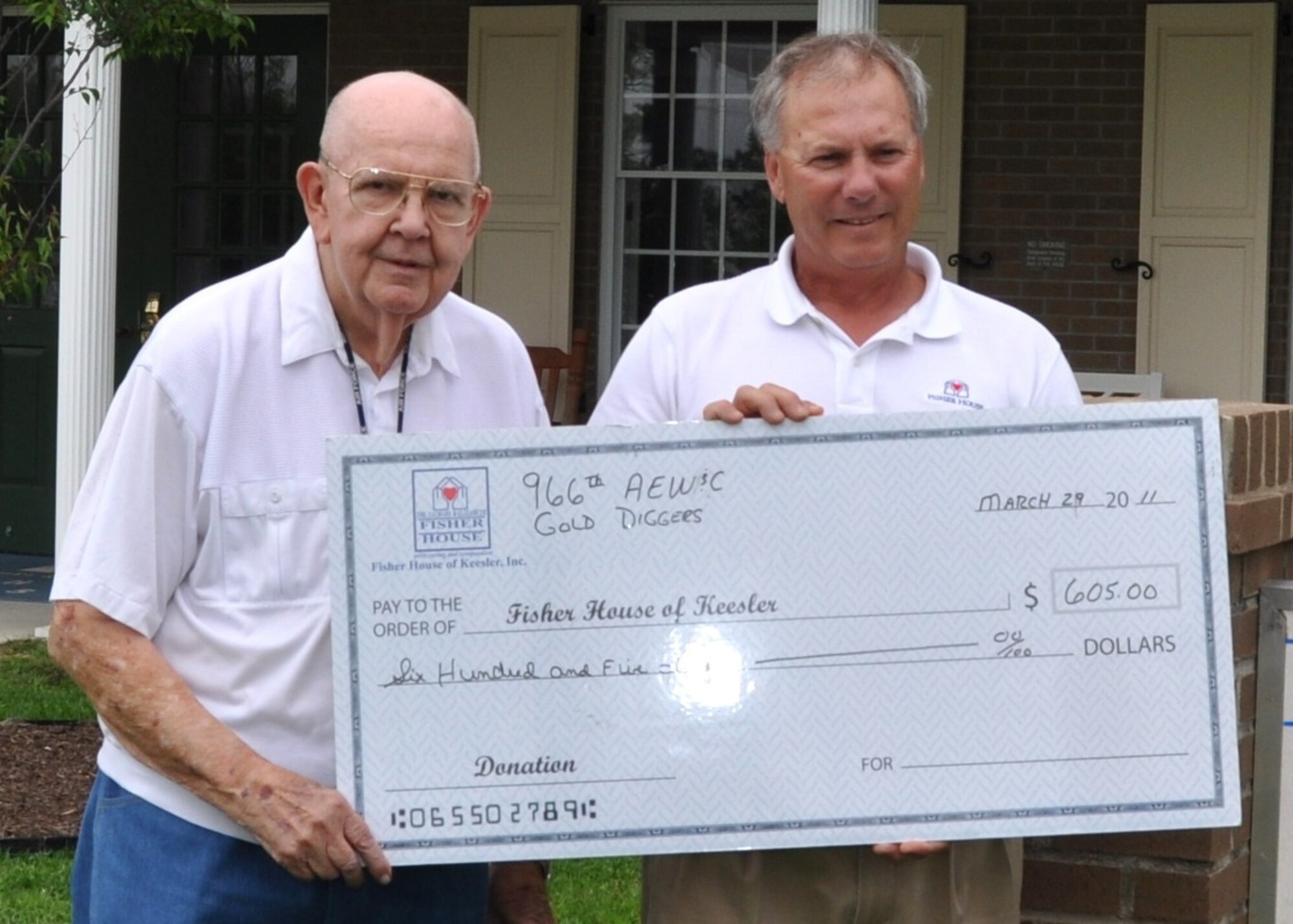 Jim Skelton, left, presents a $605 donation to Keesler Fisher House manager Larry Vetter March 29.  Mr. Skelton, a retired senior master sergeant who resides at the Armed Forces Retirement Home in Gulfport, represented the 966th Airborne Early Warning and Control Squadron “Gold Diggers,” a Vietnam war-era EC-121 Constellation unit originally from the former McCoy AFB, Orlando, Fla.  He said he had looked at a number of charities and found the Fisher House has “one of the lowest – if not the lowest – ratio of overhead versus money donated.  Ninety-six percent of donations actually go to the organization and only 4 percent to overhead.”  (U.S. Air Force photo by Steve Pivnick)