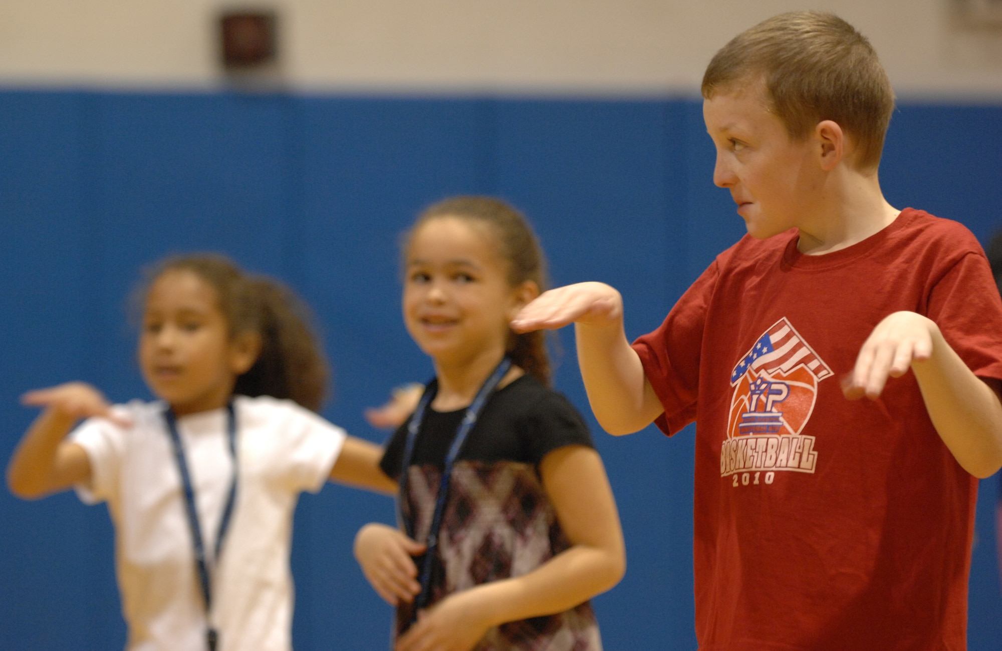 WHITEMAN AIR FORCE BASE, Mo. --Brett Butler(Right,) son of Lt. Col. Patrick Butler, Kierra Coleman(Center,) daughter of Kristi Atkins and Kyla Wellington(Left,) daughter of Staff Sgt. Angela Gooden, enjoy Zumba during Family Fitness Day April 2, 2011. The event is held annually to teach parents and children that fitness can be fun and done together. (U.S. Air Force photo by Airman 1st Class Cody H. Ramirez)
