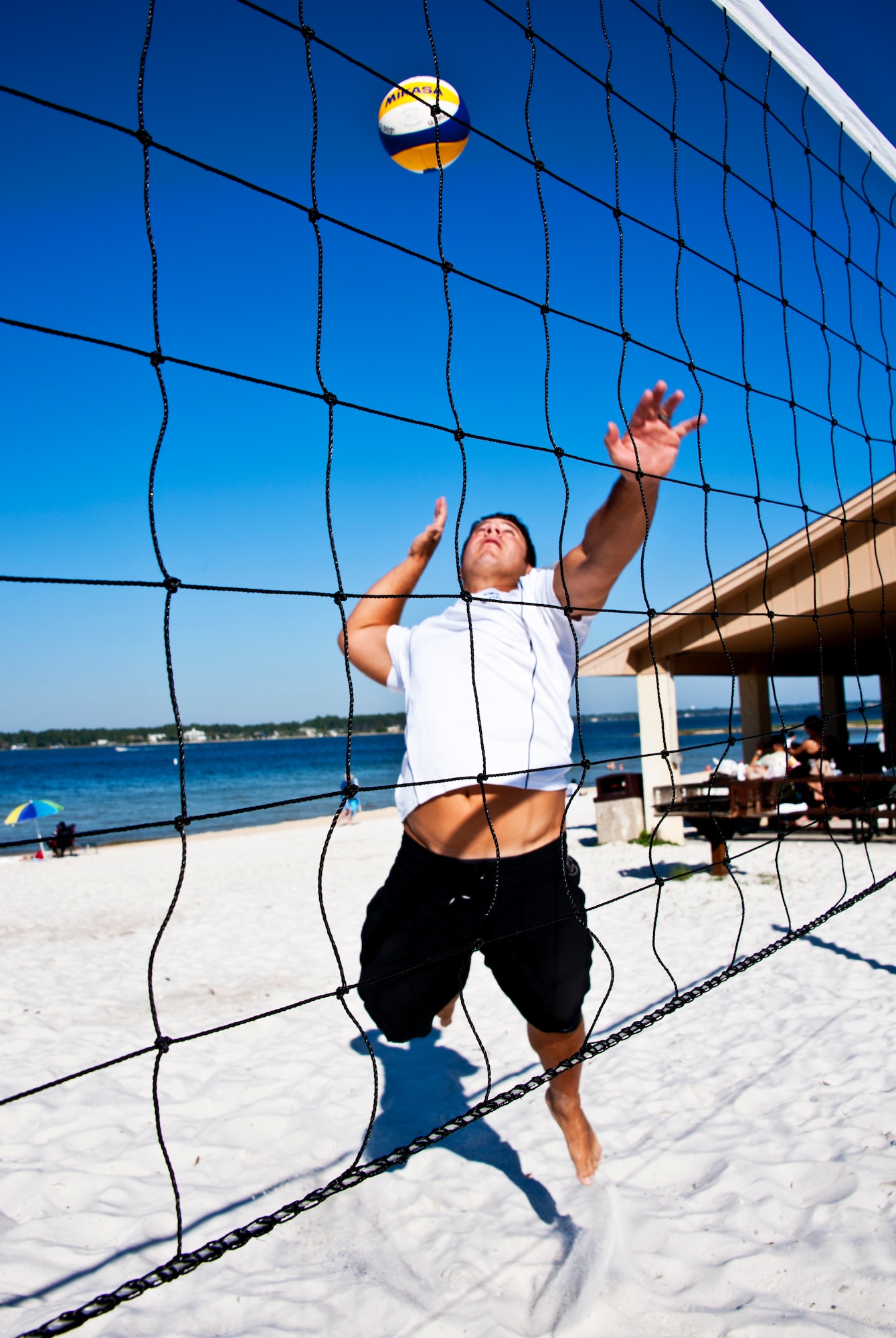Tech. Sgt. David Dean, 919th Maintenance Squadron, goes up for a spike April 3 at Eglin’s Post’l Point.  Sergeant Dean, an Air Reserve Technician at Duke Field, was recently selected for the second year in a row for the Air Force men’s beach volleyball team.  His team placed second in the armed forces tournament last year.  A first or second place finish in the tournament this year (April 12-15) allows them to play in the World Military Games in Brazil.  (U.S. Air Force photo/Tech. Sgt. Samuel King Jr.)