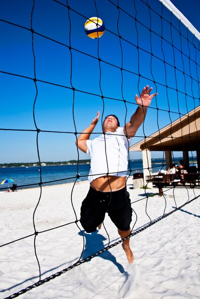Tech. Sgt. David Dean, 919th Maintenance Squadron, goes up for a spike April 3 at Eglin’s Post’l Point.  Sergeant Dean, an Air Reserve Technician at Duke Field, was recently selected for the second year in a row for the Air Force men’s beach volleyball team.  His team placed second in the armed forces tournament last year.  A first or second place finish in the tournament this year (April 12-15) allows them to play in the World Military Games in Brazil.  (U.S. Air Force photo/Tech. Sgt. Samuel King Jr.)