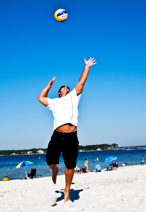 Tech. Sgt. David Dean, 919th Maintenance Squadron, leaps up for a powerful jump serve April 3 at Eglin’s Post’l Point. Sergeant Dean, an Air Reserve Technician at Duke Field, was recently selected for the second year in a row for the Air Force men’s beach volleyball team.  His team placed second in the armed forces tournament last year.  A first or second place finish in the tournament this year (April 12-15) allows them to play in the World Military Games in Brazil.  (U.S. Air Force photo/Tech. Sgt. Samuel King Jr.)