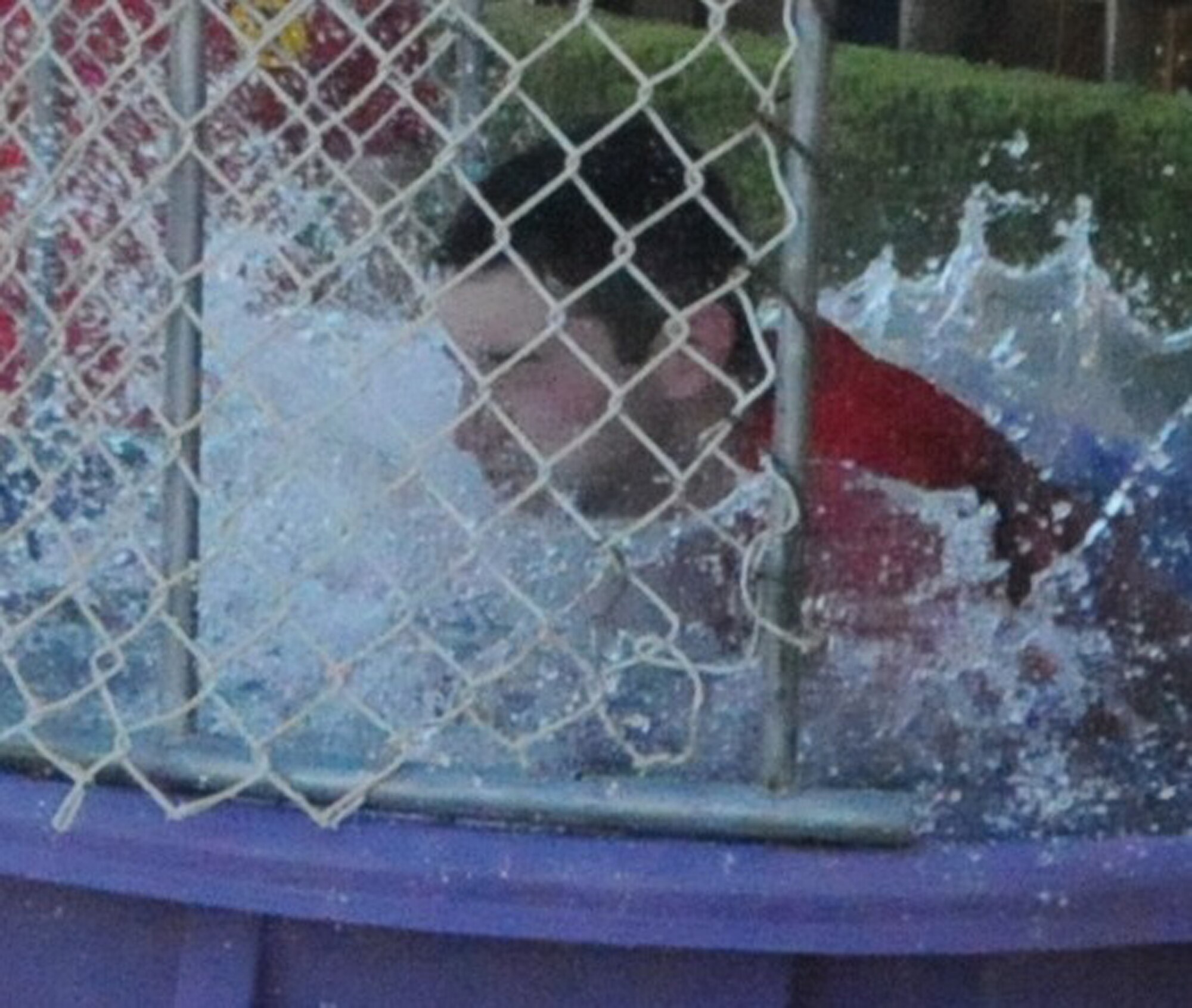 LAUGHLIN AIR FORCE BASE, Texas – First Lt. Dan Cascio, 84th Flying Training Squadron, splashes into the water of a dunk tank at the T-6 Carnival near Laughlin’s flight line April 1. The Carnival also included horseback riding, a bouncy castle, carnival games, a burger burn and an ice cream-eating contest. (U.S. Air Force photo by Airman 1st Class Blake Mize)    